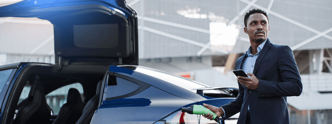 Man standing next to EV charging